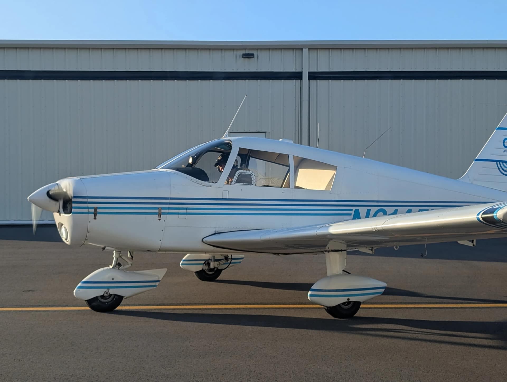Close view of the Piper Cherokee 140’s classic lines on the ground at golden hour